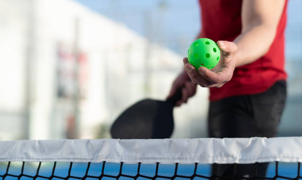 istock Man playing pickleball in court: pickle ball serving 2149368387