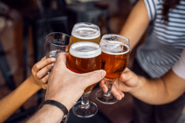 istock Hand's of young friends toasting with beer while having fun in a restaurant. 2149369526
