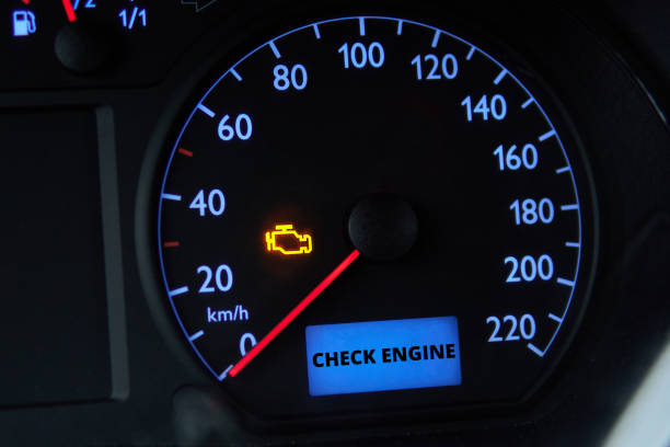 check engine error light illuminated on car dashboard - motor stockfoto's en -beelden