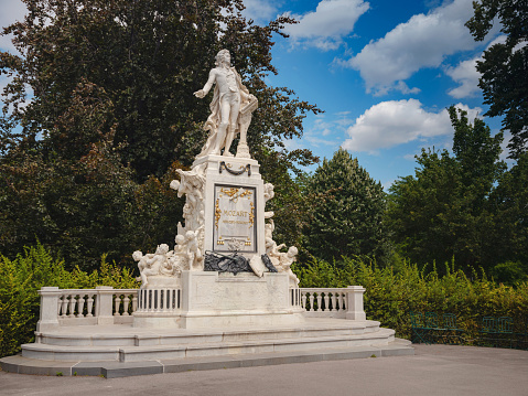 Wolfgang Amadeus Mozart Statue in Vienna Wien, Austria in sunny summer day. Monument in memory in Burggarten, public park