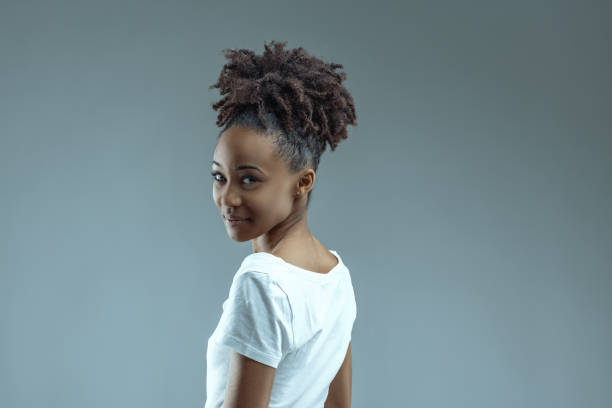 istock Over shoulder glance, joy in Afro-style hair 2149371590