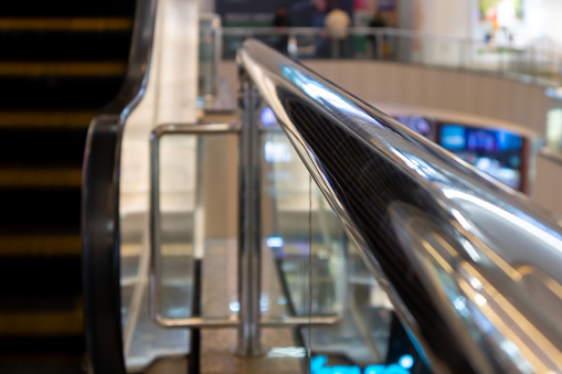 Glass railing with stainless steel handrail in a shopping center