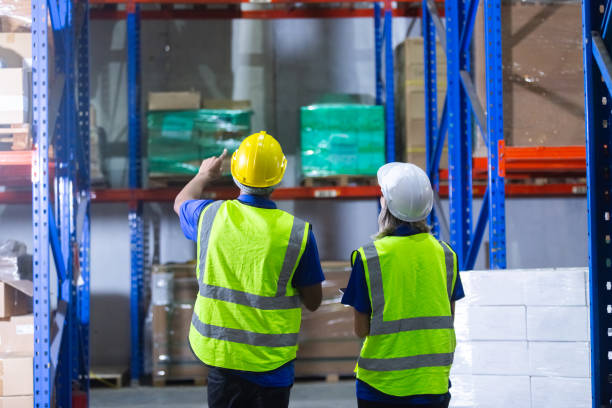 istock Group worker warehouse working brainstorm checklist product to shelf in warehouse store. Logistics factory industry supervisor manufacture. business logistics and transport. 2149377254