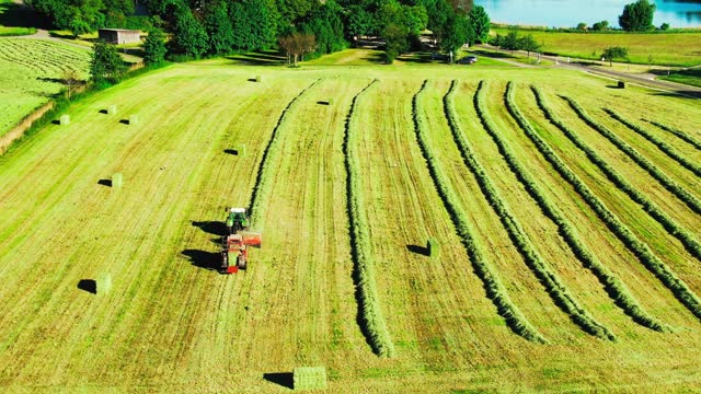 Tractor Machine Working on Hay Bales in Agriculture Field stock video