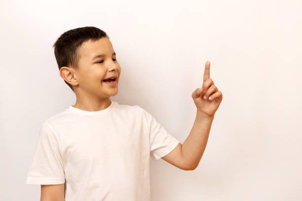 istock The boy raised his index finger, attracting attention. 2149380020