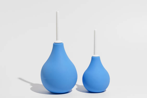 istock Two blue rubber enemas - larger and smaller on a gray isolated background. The concept of pharmacy, medical preparations for cleansing the intestines and detoxifying the body. 2149382237
