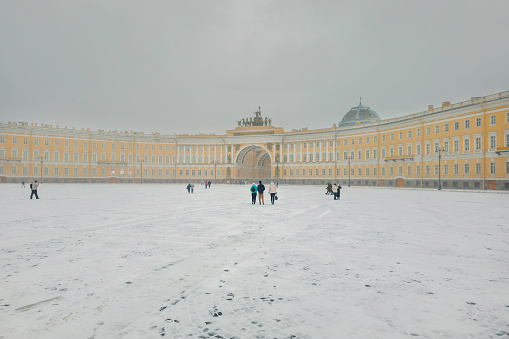 Saint Petersburg, Russia - April 19, 2024: Sudden snowfall, storm warning. Landscape views of the State Hermitage Museum in the spring stormy weather. Famous place for tourists in Saint Petersburg.