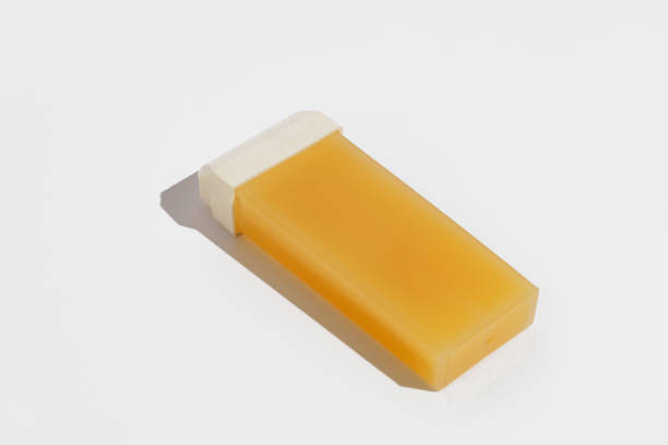 istock Yellow replaceable wax cassette for depilation on a white isolated background. Concept of body hair removal, beauty procedures 2149388042