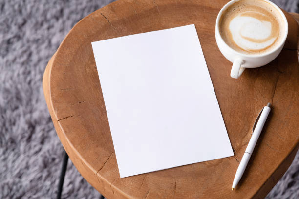 istock blank notepaper mockup on coffee table with cappuccino, pen and grey rug 2149388998