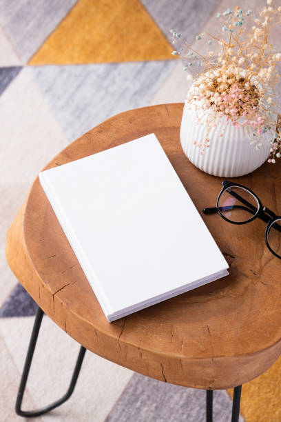 istock blank book mockup on coffee table with decoration flowers and colorful rug 2149389030