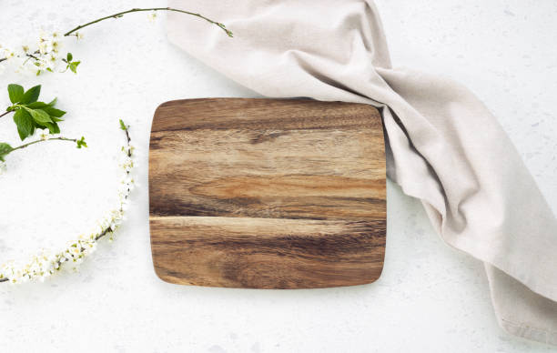 istock Cutting board top view, kitchen wooden tray decorated with  cloth on white table.Food backdrop. 2149389055