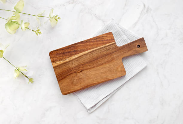 istock Cutting board top view, kitchen wooden tray decorated with  cloth on white table.Food backdrop. 2149389062