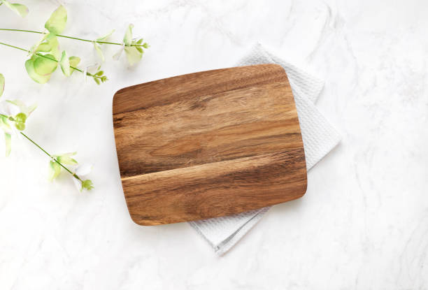 istock Cutting board top view, kitchen wooden tray decorated with  cloth on white table.Food backdrop. 2149389069