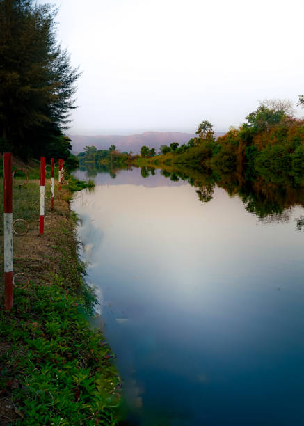 Landscape view of Sri Nakarin Dam is a water storage dam for electricity generation and agriculture in the middle of a valley in Kanchanaburi, Thailand.