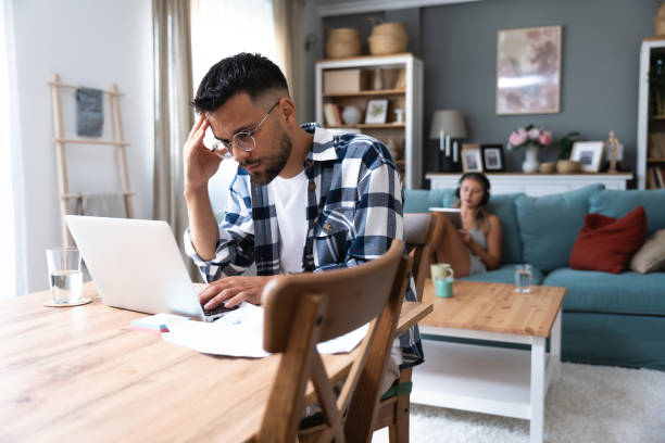 istock Young freelance business finance man has a problem with attention deficit hyperactivity disorder (ADHD) he cant start work on new project Male lost concentration cant work from home on laptop computer 2149389223