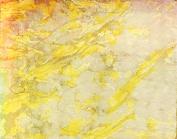 Marbled yellow and gold paper background texture