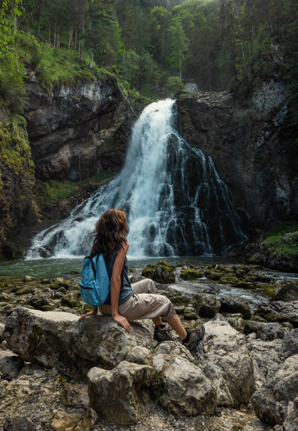 istock Female traveler at the waterfall in Austria 2149391730