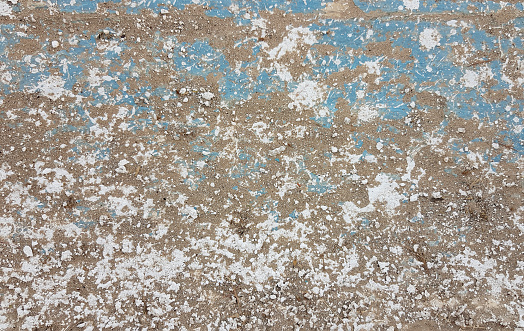 Old painted stucco background with white, blue and brown pattern