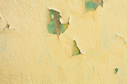 Grunge yellow stucco plaster wall background texture