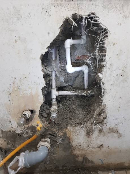 istock Damaged wall exposing burst water pipes after flood 2149391881