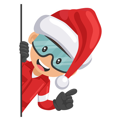 Industrial mechanical worker with Santa Claus hat peeking out from behind a wall pointing finger. Merry christmas. Express an idea and indicate it with the index finger