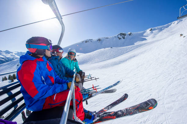 istock Friends ski down slope at ski resort 2149394202
