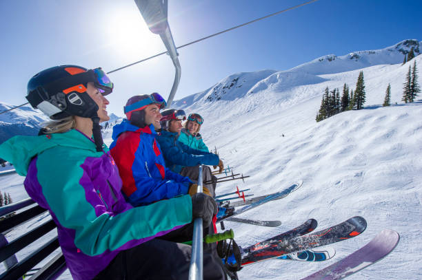istock Friends ski down slope at ski resort 2149394203