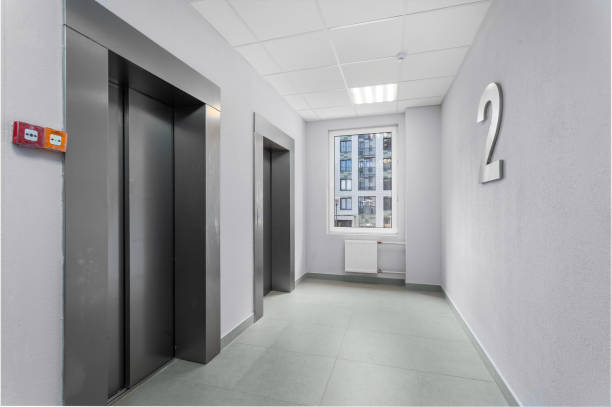 istock A corridor with two elevators and a window overlooking the city, with a large number of floor '2' on the wall. 2149394216