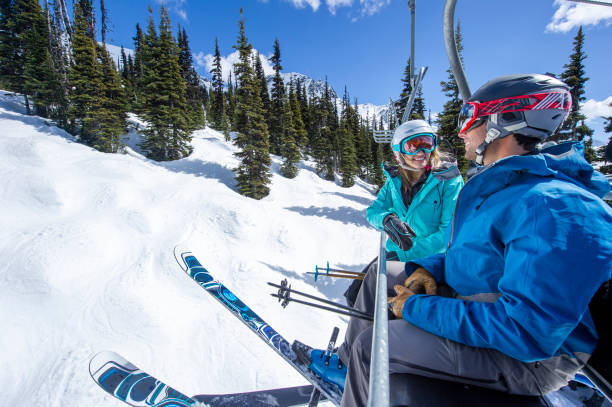 istock Friends ski down slope at ski resort 2149394425