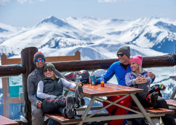 istock Friends ski down slope at ski resort 2149394471