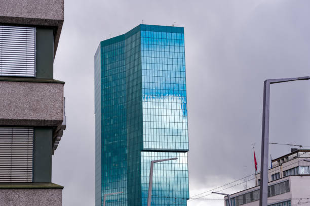 istock Modern office tower at Swiss town with reflections of cloudy sky on a cloudy spring day. 2149396543