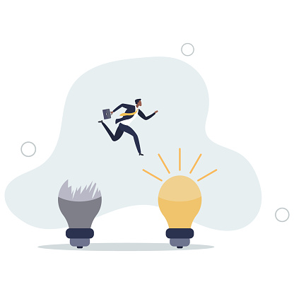 businessman jump from old to new shiny lightbulb idea.change management or transition to better innovative company,
