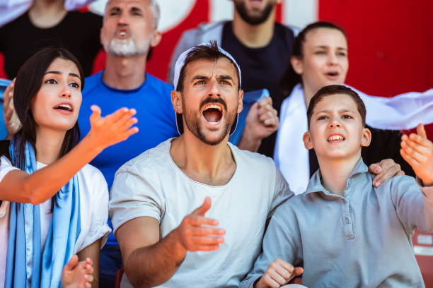 istock Sport fans cheering at the game on stadium. . 2149397846