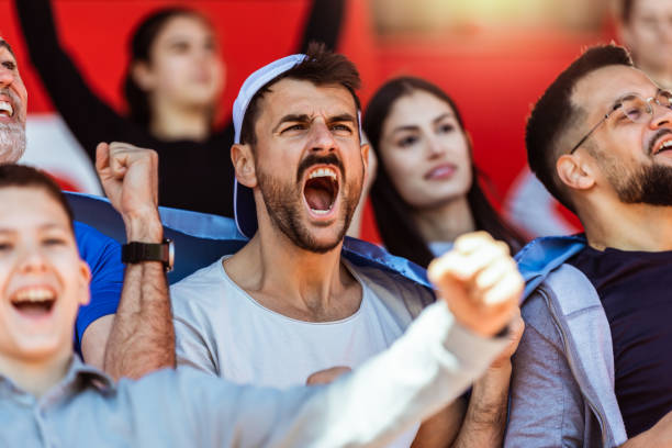istock Sport fans cheering at the game on stadium. . 2149397863