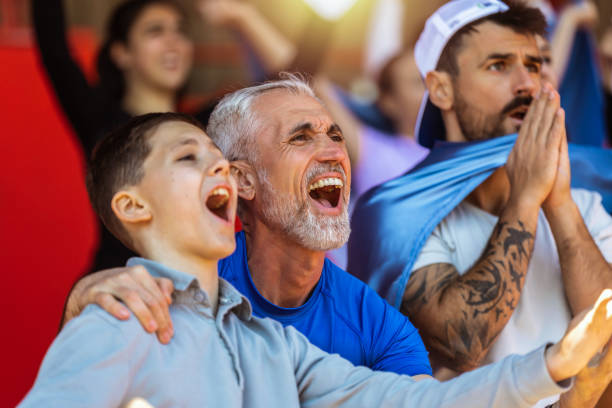 istock Sport fans cheering at the game on stadium. . 2149397912