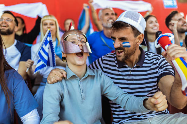 istock Fans celebrating with flags and scarfs. 2149397988