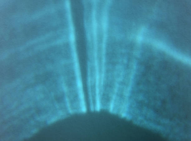 Fan shaped monochrome abstract background or backdrop. Sunlight reflected and refracted through aquamarine or turquoise glass. Similar to an ultra sound scan pattern