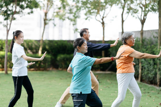 istock Asian seniors practicing Tai Chi at public park 2149398705
