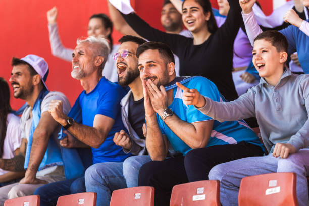 istock Sport fans cheering at the game on stadium. . 2149398962