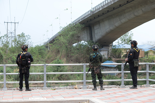 Mae Sot, Tak, Thailand - April 14, 2024 : Thai soldiers with weapons are stationing at the strategic location of the 2nd Friendship Bridg border Thailand, Mae Sot, Tak.