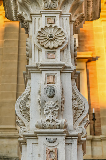Medieval stone decoration in ancient pedestal structure, Seville, Spain