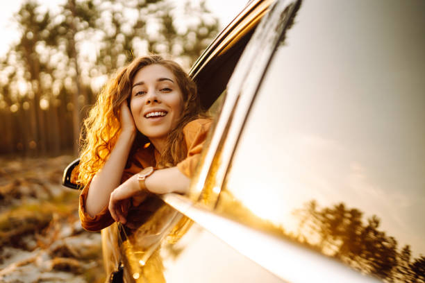 istock Young woman sitting in car and leaning on window . 2149402223