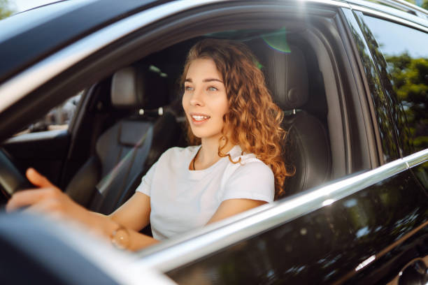 istock Young woman driving a car. 2149402495