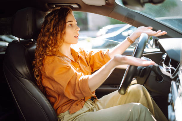 istock Young woman driving a car. 2149402509