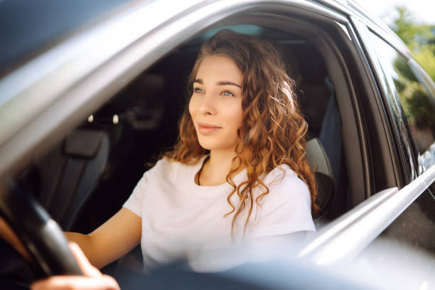 istock Young woman driving a car. 2149402521