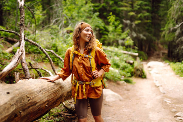 istock Hiking woman walk with a hiking backpack in spring green forest. 2149405230