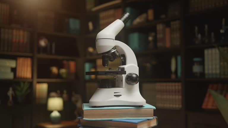 A microscope rotating slowly at the library on a stack of books, HQ 4K footage