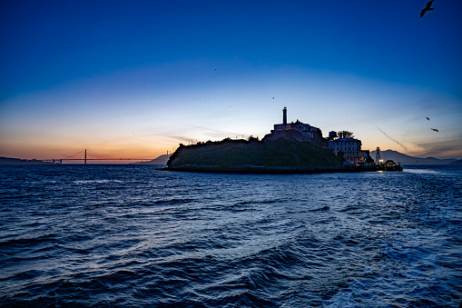 Alcatraz Island seen from ferry boat during springtime night sunset in San Francisco