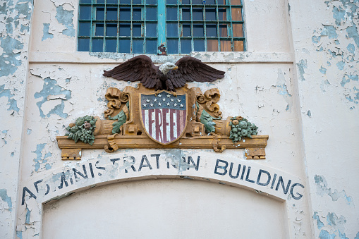 Alcatraz Administration building sign above entrance door of prison in San Francisco during springtime day