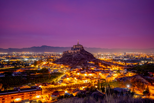 Panoramic pre-dawn view of the Murcia orchard, with the medieval castle of Monteagudo, Murcia, Spain with beautiful colors